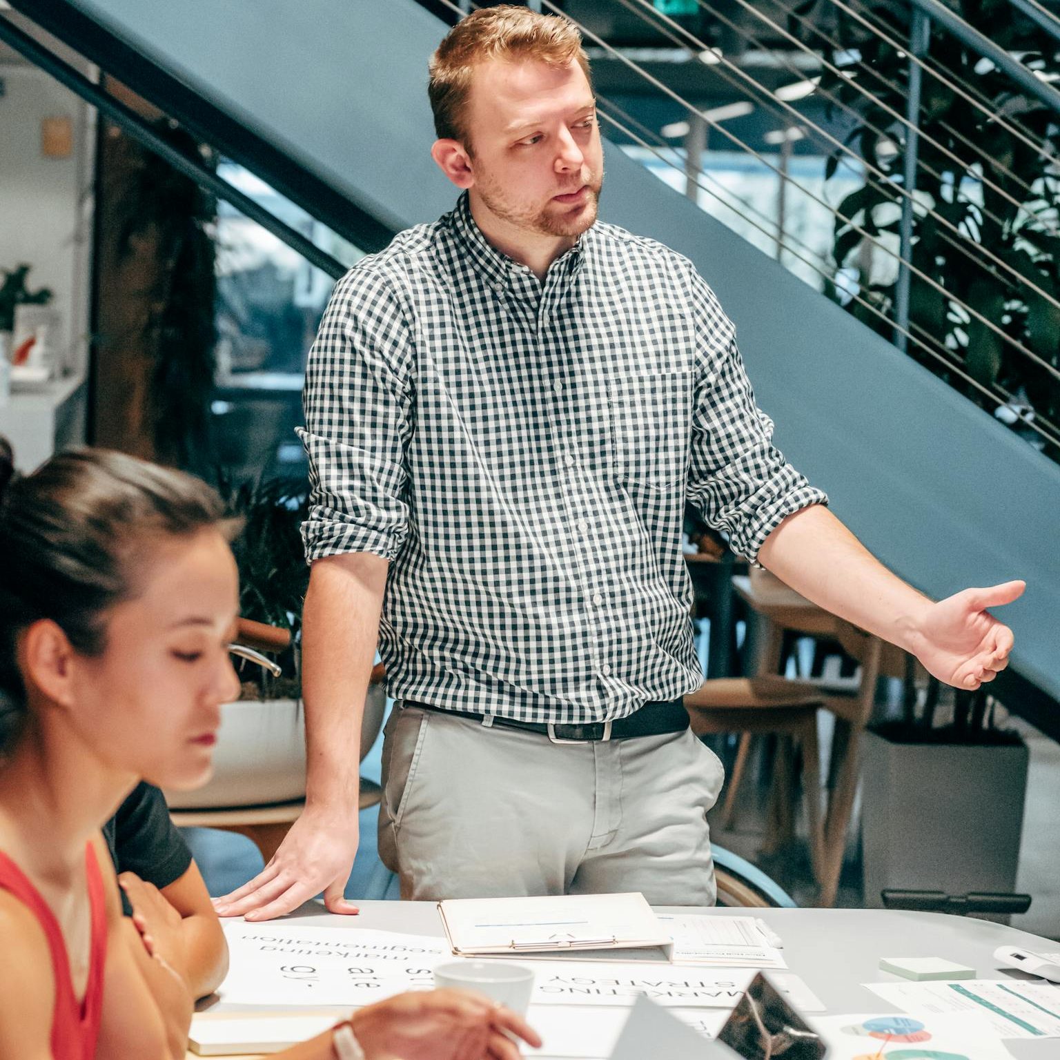 Diverse team collaborating in a modern office setting, discussing project details.